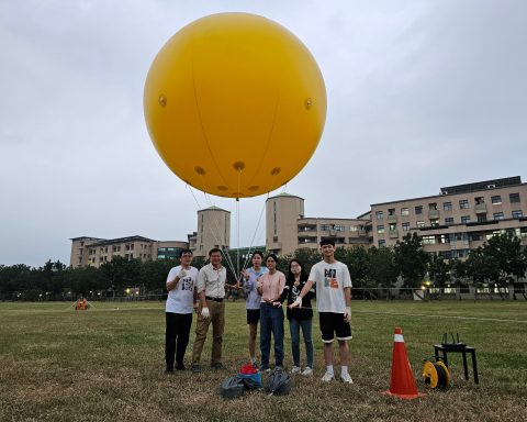 高雄大學資管系副教授蕭漢威（左二）指導學生開發「懸吊式座標載具移動系統」。（高雄大學提供）